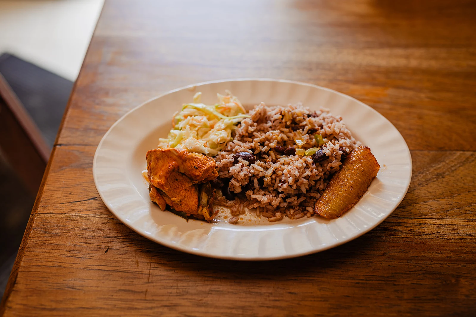 Belizean rice and beans plate served with plantain and chicken